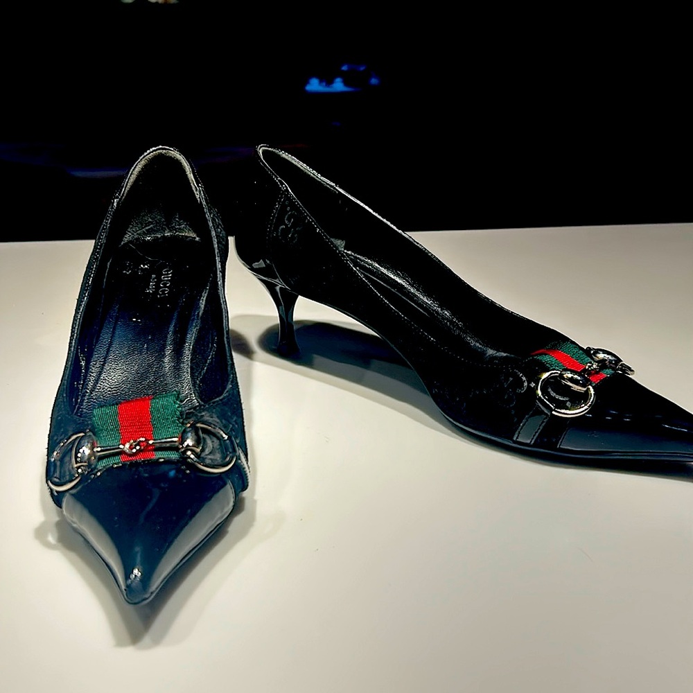 Black patent leather kitten heels with metal and ribbon details